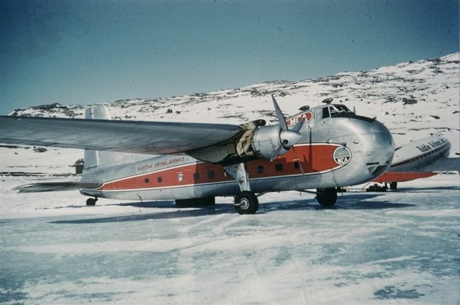 A Maritime Central Airway (MCA) Bristol Freighter on the ice strip at the base of the hill where FOX-C will ultimately be built. May 1955.