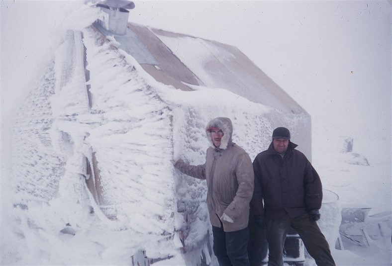 L to R: Scoville & Galli with their rime ice covered living quarters. Sept 1955.