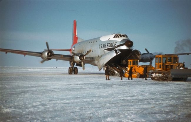 A USAF C-124 delivering a Caterpillar D-6 loader. March 1956.