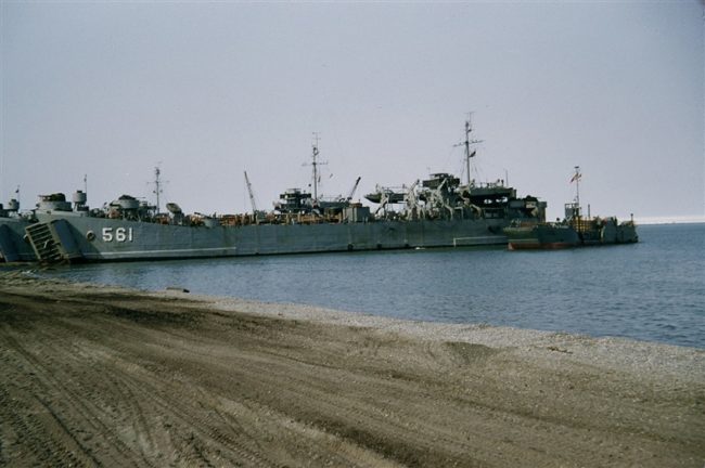Beached LST's disgorging their construction material. Aug 1953.