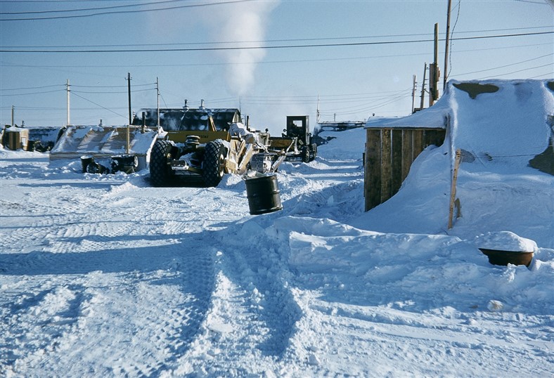 Removing snow from the construction camp living area. March 1956.