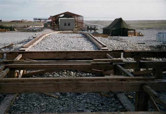 Photo shows the rail system used to haul the individual modules from the erection tent to the train foundation. July 1953.
