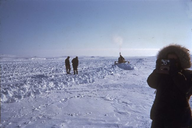 D-4 Caterpillar working to prepare the ice airstrip. The guy on the right is taking a photo of the guy taking the photo!. April 1955.