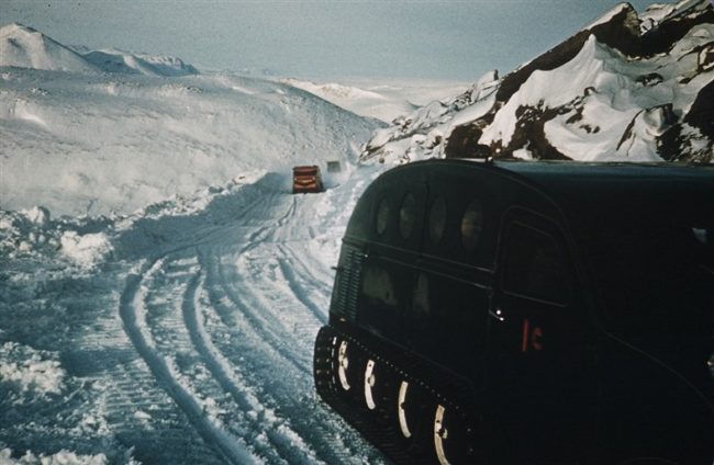 Bombardier snowmobiles on the road to the site from the airstrip. Feb 1957.