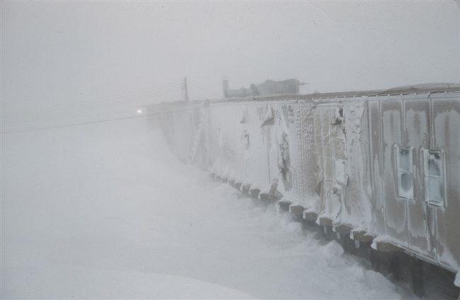 View of the snow-blown module train taken from the top of a snow drift. March 1956.