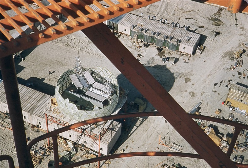 A view from the Dopplar tower of the radome construction. The power modules containing the generators are shown in the upper right of the photo. Aug 1956.