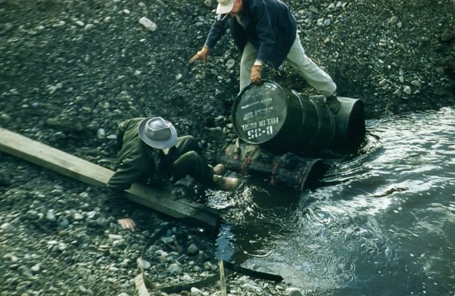 Wilson & Hope slip while removing an obstruction from the culvert. June 1956.