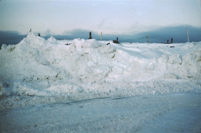 Construction camp buildings buried in snow. Oct 1956.